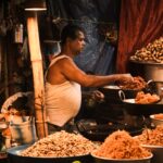 Street vendor at a market stall in India